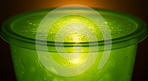 Close-up of a Dewy Green Plastic Container