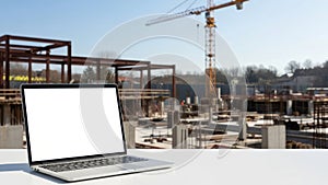 Laptop on construction site, isolated on white background
