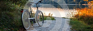 Bicycle by tranquil lakeside path