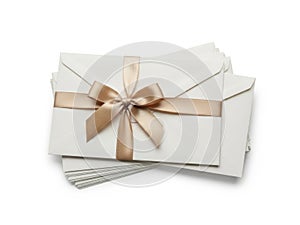 Stack of envelopes with ribbon isolated on white background
