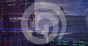 Image of financial data, binary code and graphs over city buildings