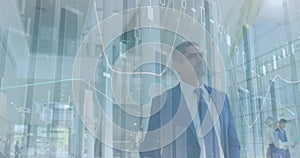 Image of financial data over caucasian businessman over caucasian businessman