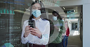 Image of financial data over diverse business people in face masks queueing in corridor