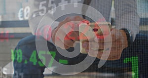 Image of financial data processing over caucasian businessman using smartphone