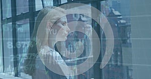 Image of financial data processing over caucasian businesswoman in office