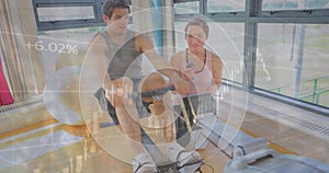 Image of financial data processing over caucasian man exercising with female trainer on gym