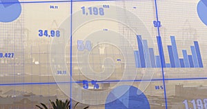 Image of financial data processing over cityscape