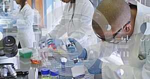 Image of financial data processing over diverse scientists working in lab