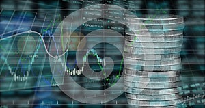 Image of financial data processing over stack of silver coins