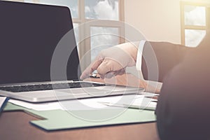 Image of finger pushing the power button on laptop computer