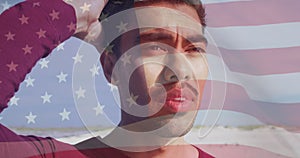 Image of flag of united states of america and biracial man on beach
