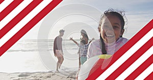 Image of flag of united states of america over biracial couple with children on holiday by sea