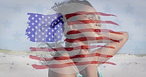 Image of flag of united states of america over biracial woman on beach