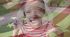 Image of flag of united states of america over happy african american girl