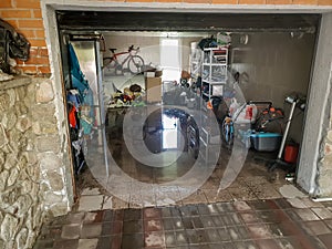 Image of flooded garage after heavy rain. Wet floor and floating thing in house after flood