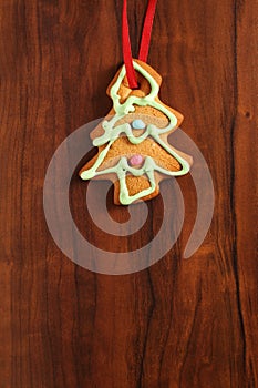 Image of gingerbread Christmas tree cookie over brown wooden tex