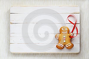 Image of Gingerbread man on white vintage cutting board