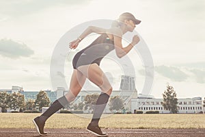Image of a girl standing on the start line of the track. Running concept