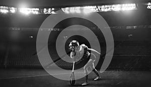 Image of a girl in the uniform of an American football team player preparing to play the ball at the stadium. Sports concept