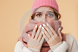 Image of girl wearing winter hat and scarf frowning and being surprised