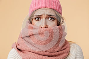 Image of girl wearing winter hat and scarf frowning and being upset