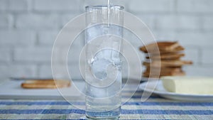 Image with a Glass from the Kitchen Table Filled with Cube Ice and Fresh Water