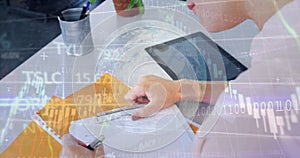 Image of globe and graph over hands of caucasian girl writing