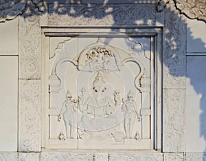 Image of the god Ganesh with his two wives and Shiva with Parvati on the wall of public hindu temple Lakshmi Narayana photo
