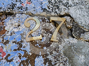Image of golden numbers on wall close up