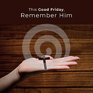 Image of good friday text over hand holding cross