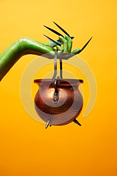 Image of green troll hand with bowler hat .