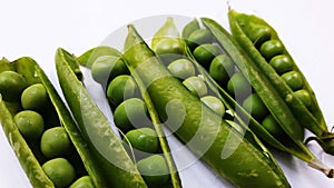 image of half pealed green pea isolated on white background