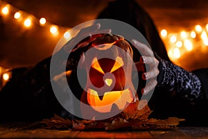 Image of halloween pumpkin cut in shape of face with witch