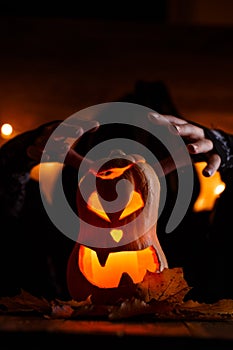 Image of halloween pumpkin cut in shape of face with witch