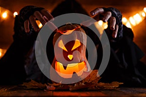 Image of halloween pumpkin cut in shape of face with witch