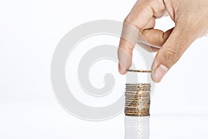 Image of Hand put coins to stack of coins with copy space background-saving concept