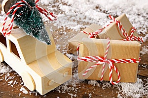 Image of handmade gift boxes over snowy wooden table