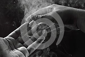 Image of hands and smoke