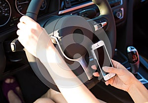 Image hands, woman sending text message on smart phone while driving to work