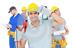 Image of handsome architect holding drill machine