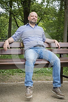 handsome bearded man sitting outdoors