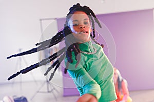 Image of happy afican american female hip hop dancer in studio