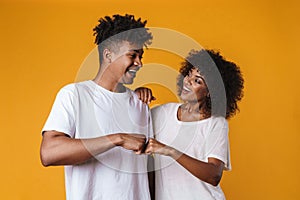 Image of happy african american couple smiling and giving fist bump