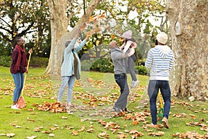 Image of happy african american multi generation family having fun in autumn garden