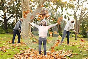 Image of happy african american multi generation family having fun in autumn garden