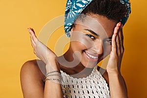 Image of happy african american woman smiling and looking at camera