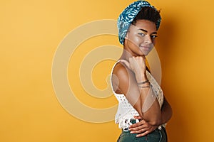 Image of happy african american woman smiling and pointing finger aside