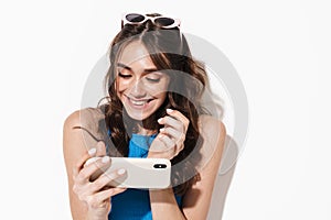 Image of happy beautiful woman using cellphone and smiling