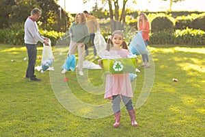 Image of happy multi generation caucasian family collecting waste in garden