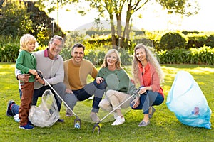 Image of happy multi generation caucasian family collecting waste in garden